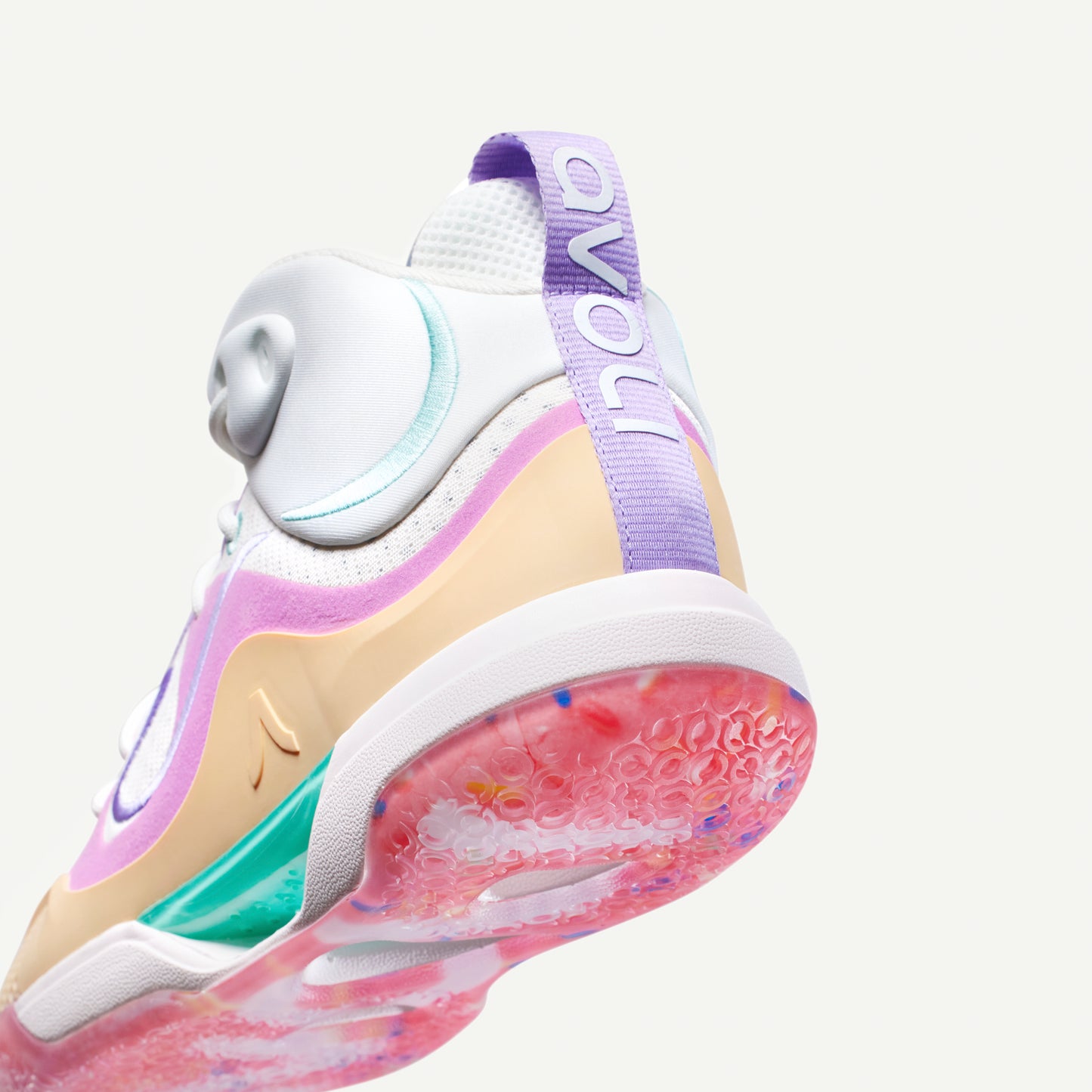 Colorful mid top sneaker with a white, pink, yellow, and red design on a white background