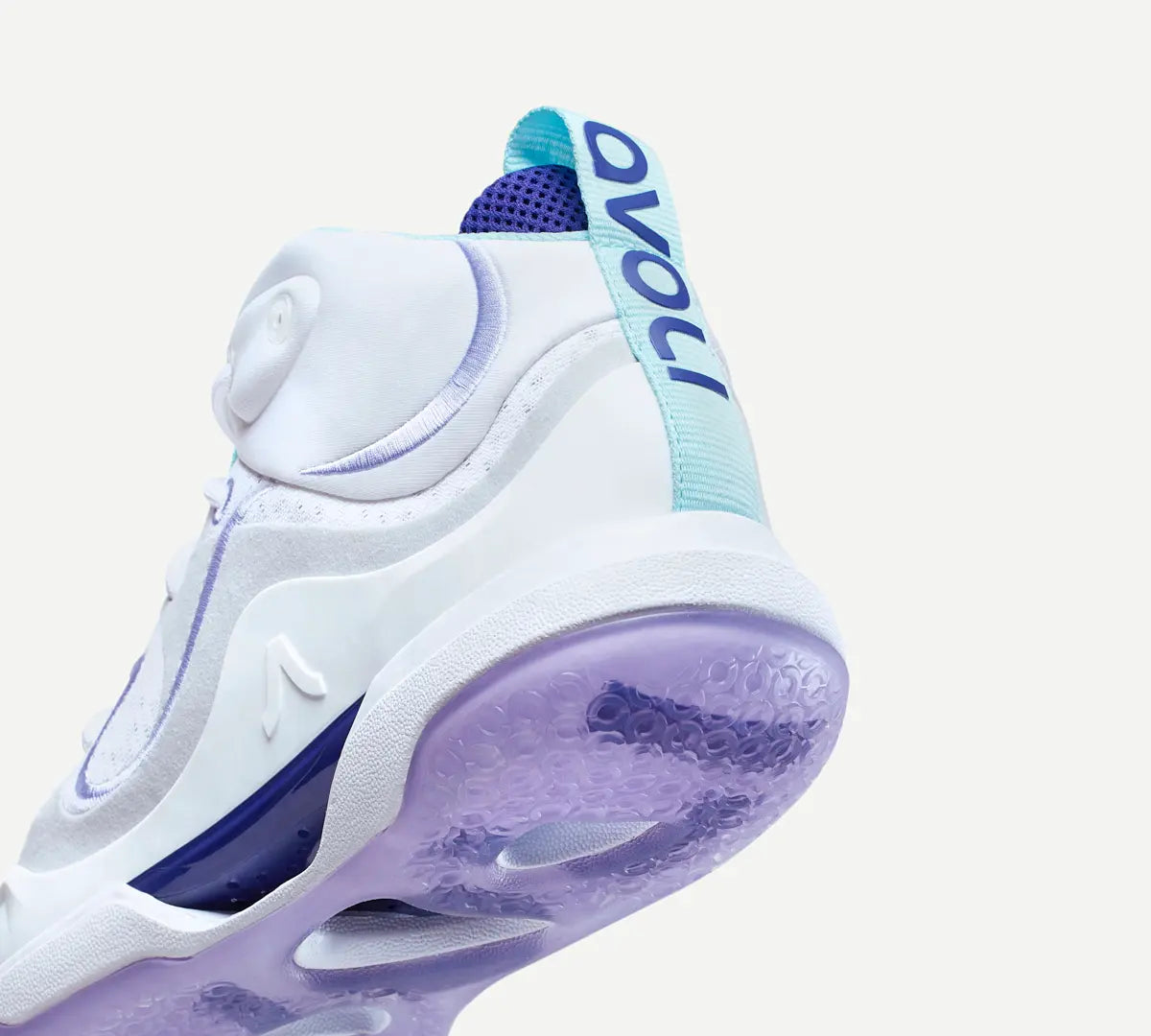 Heel view of a white volleyball shoe with purple accents 