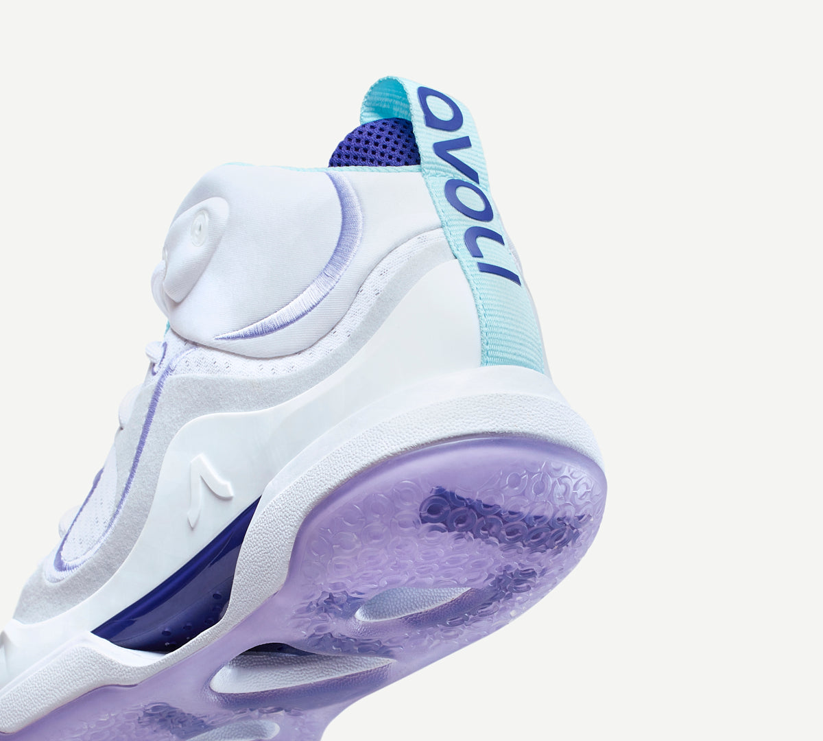 Heel view of a white volleyball shoe with purple accents 