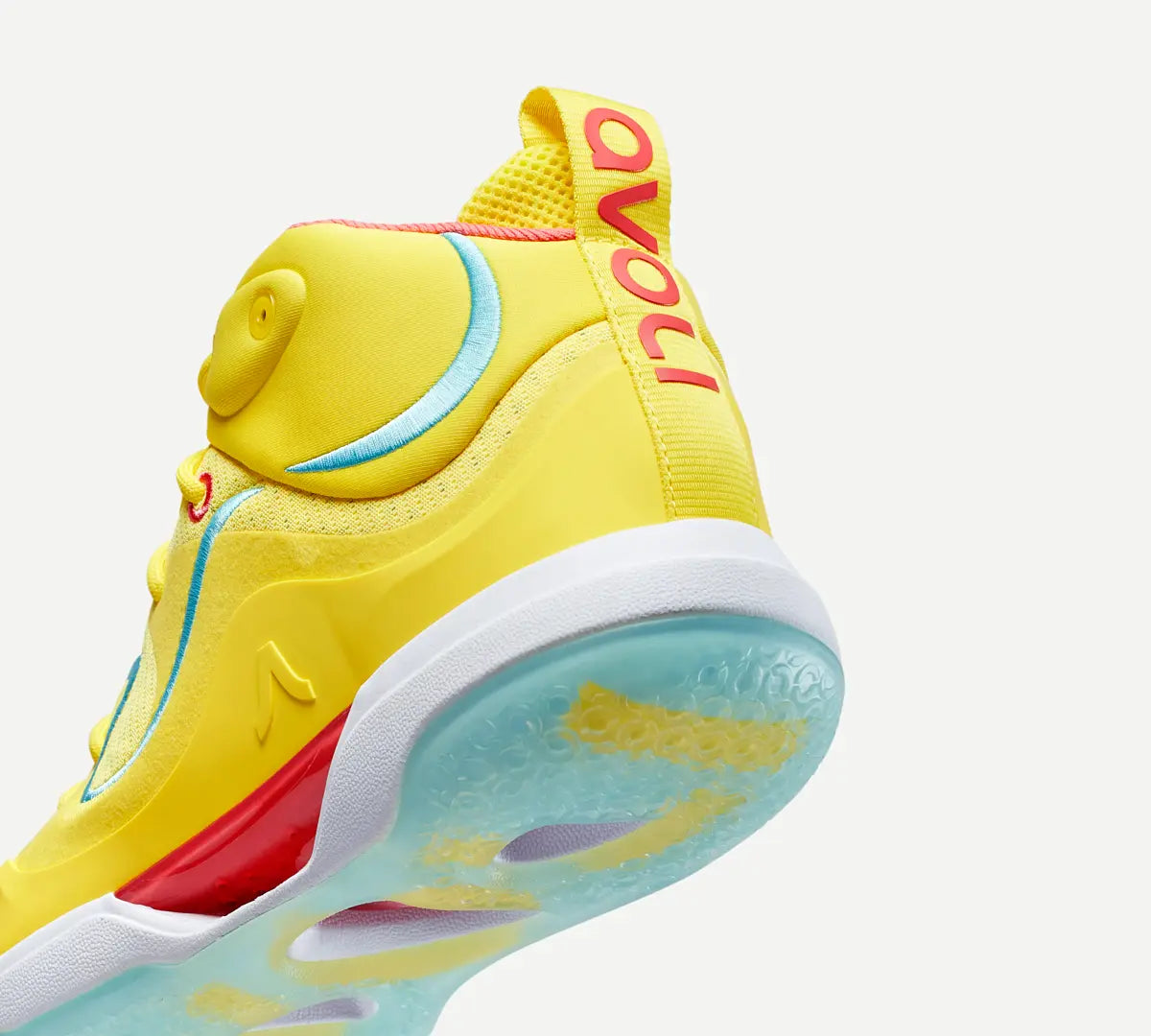 Heel view of a yellow volleyball shoe with blue accents and a white midsole.