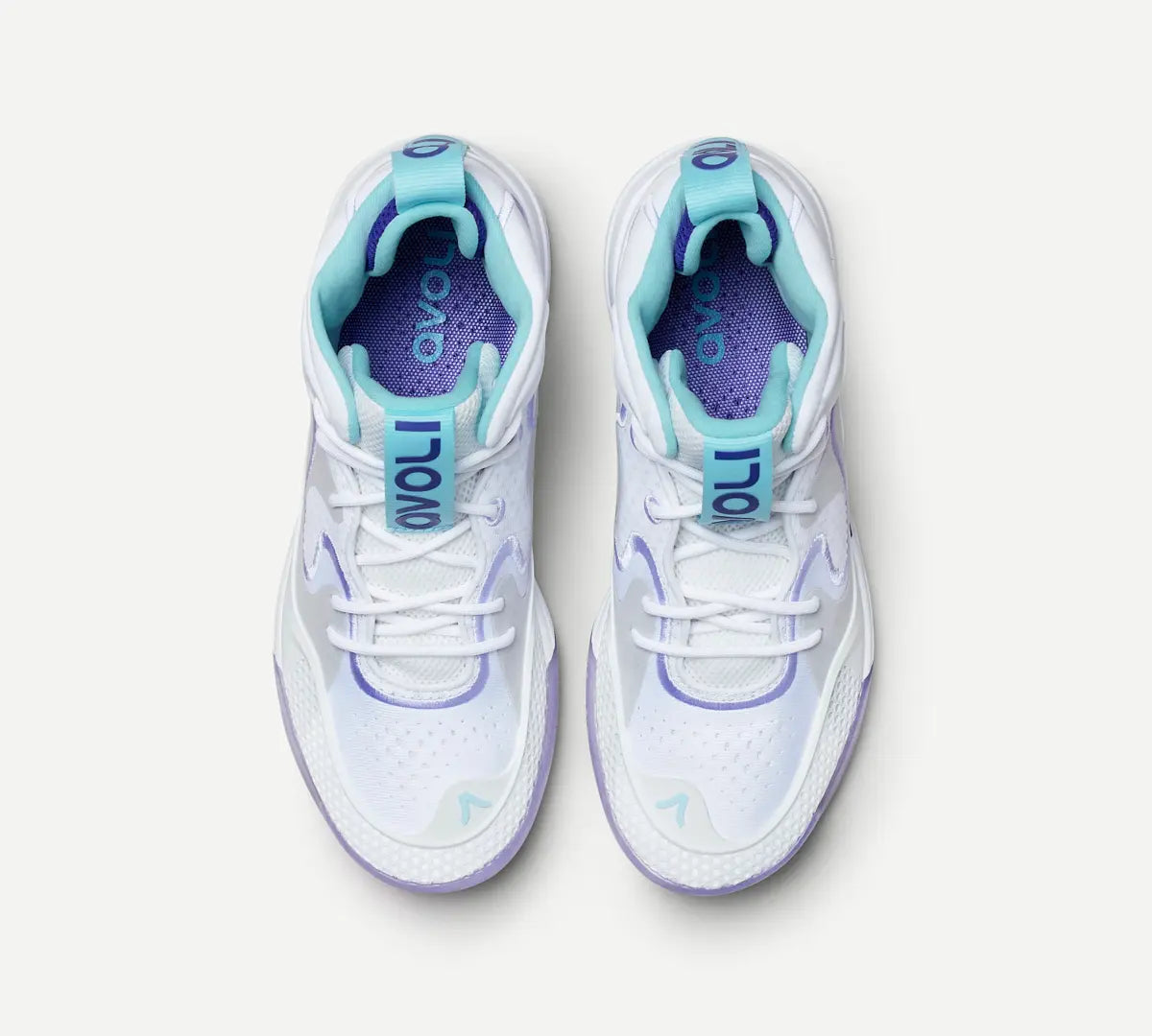 A pair of white volleyball shoes with purple accents 