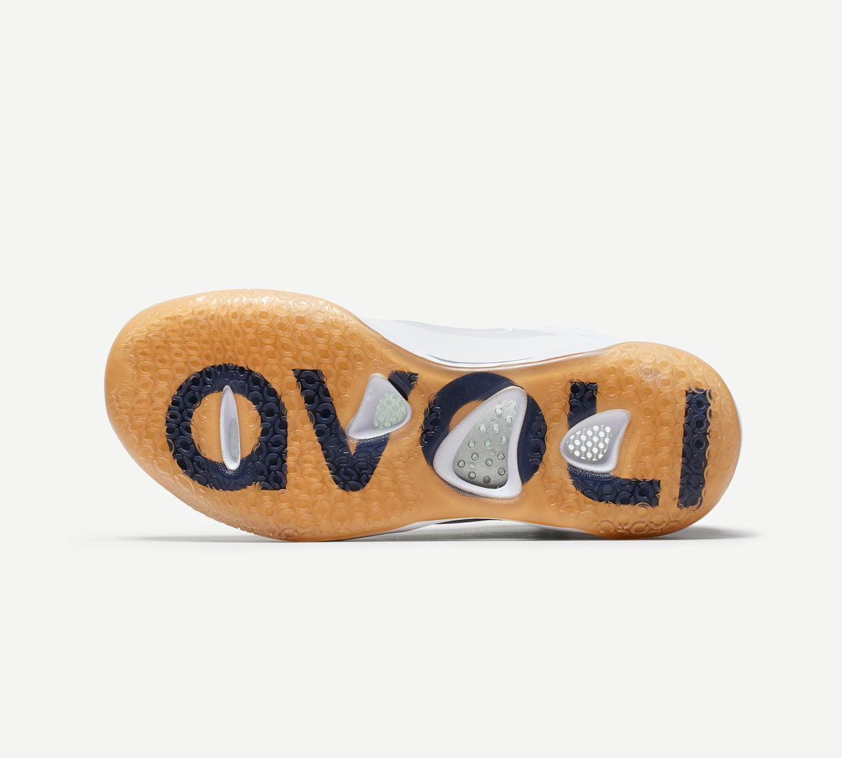 Outsole of a white mid-top volleyball shoe with a gum-colored sole