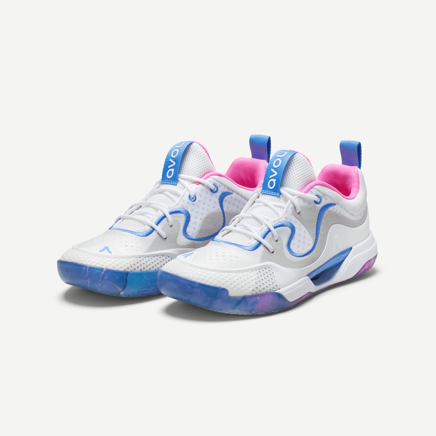 A white volleyball low top shoe with blue and pink accents, featuring a distinctive design on the sole and a label with the brand name 'Avoli' on the heel.