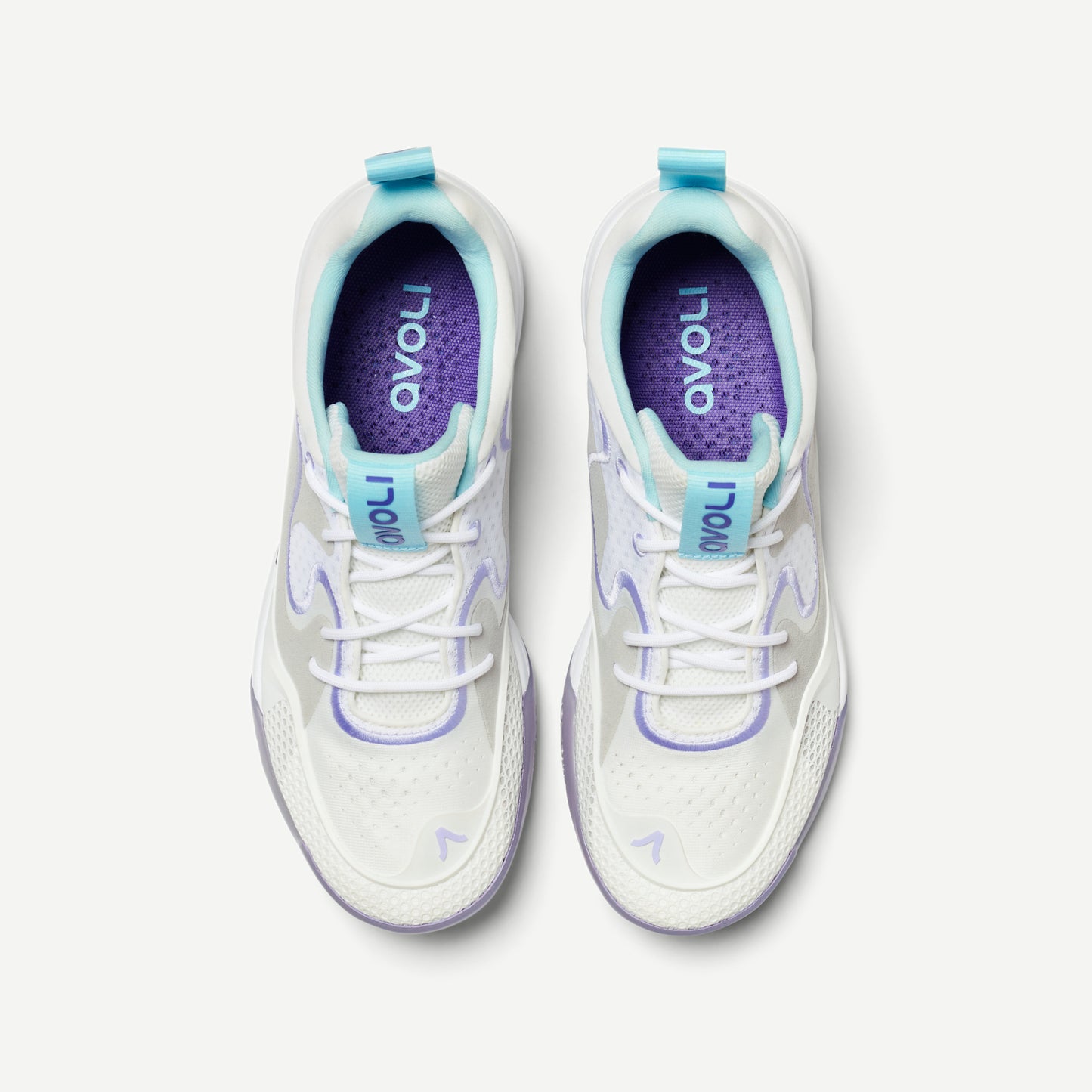 A pair of a white low top volleyball shoes with purple accents and a heather pattern