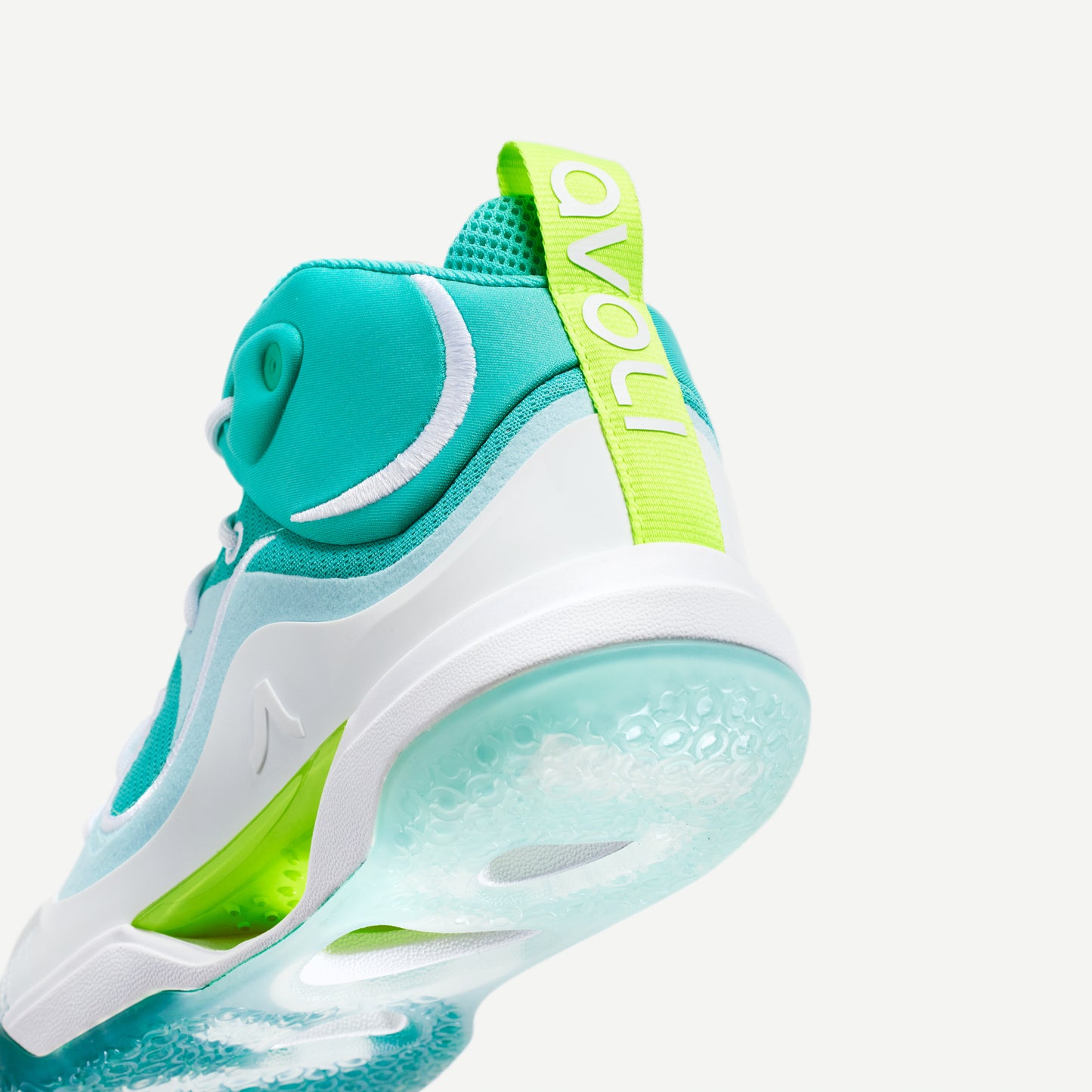 Heel view of a white and green mid-top volleyball shoe with reinforced toe protection and superior traction designed for court play.