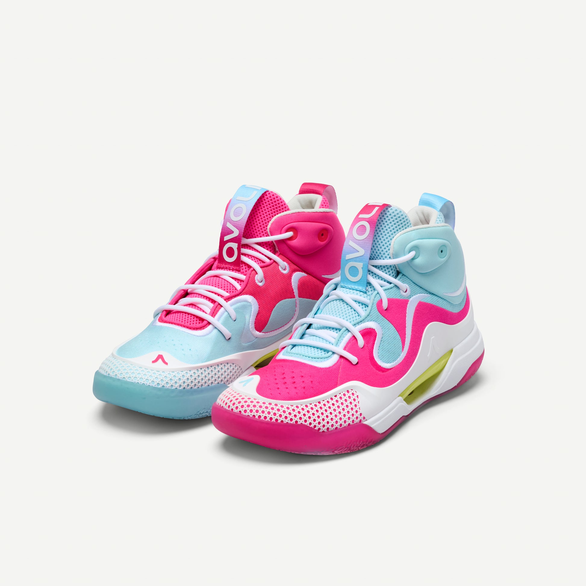 Mismatched pair of pink and light blue mid top volleyball sneakers on a white background