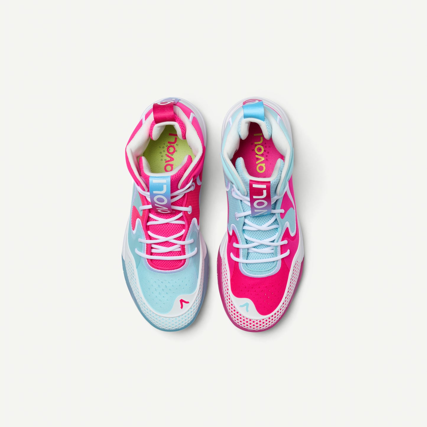 Mismatched pair of pink and light blue mid top volleyball sneakers on a white background