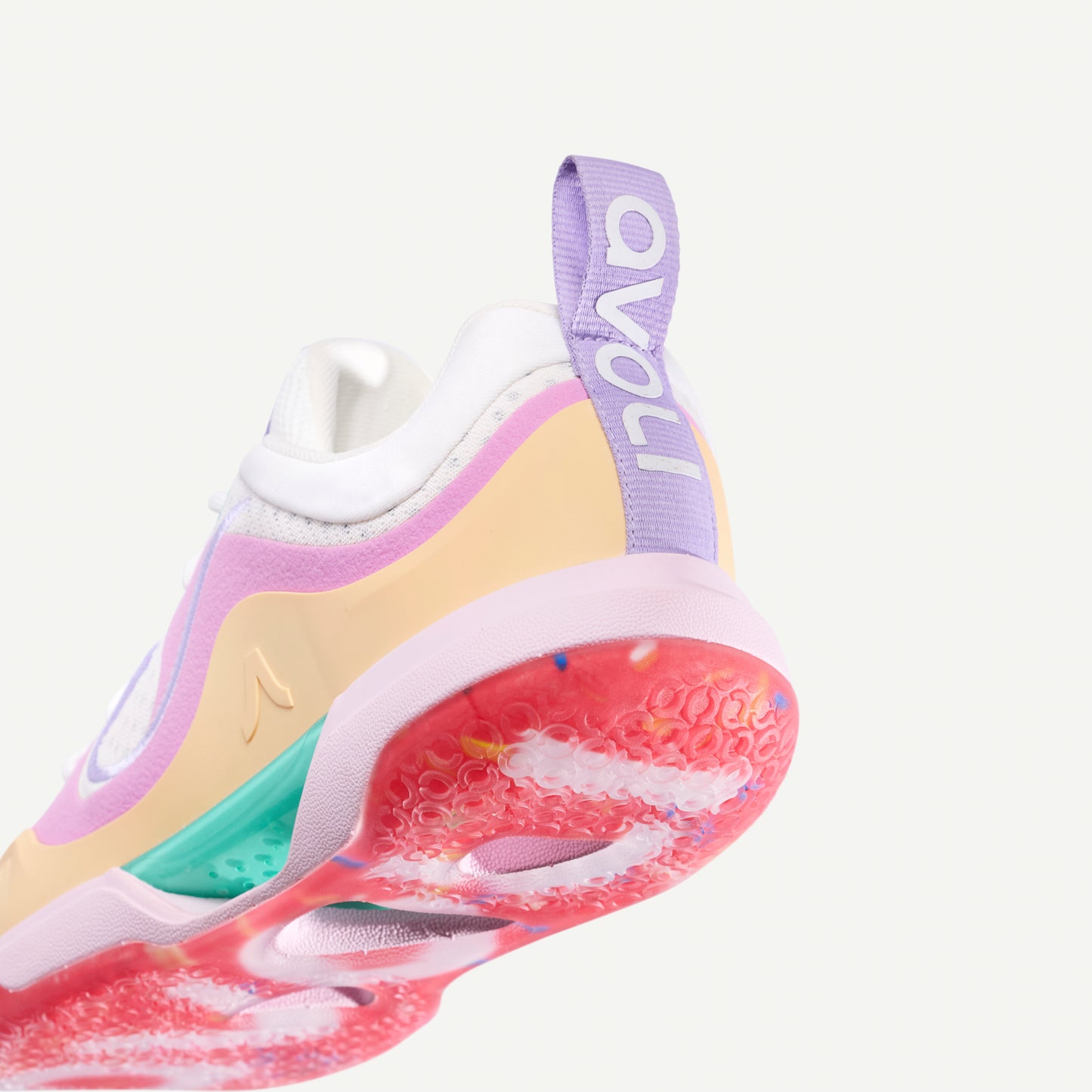 Colorful low top volleyball sneaker with a white, pink, yellow, and red design on a white background