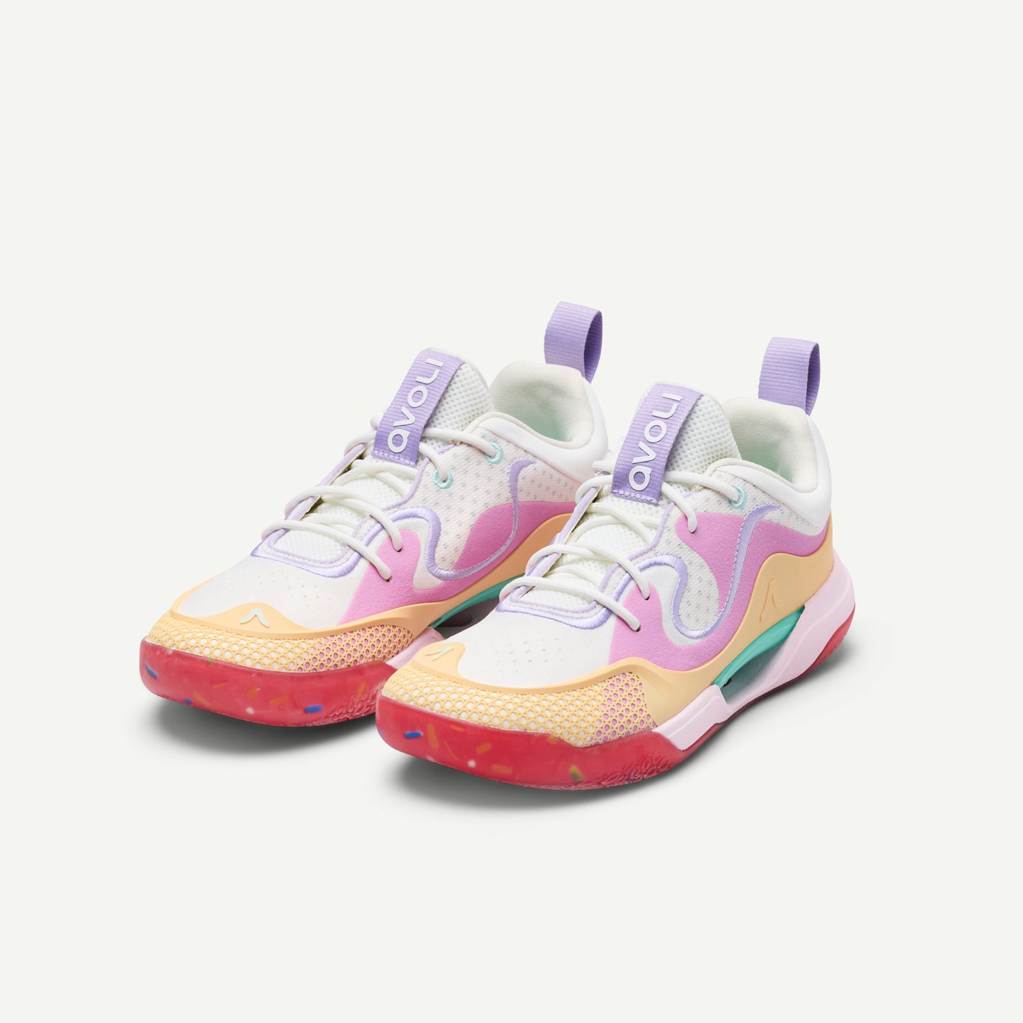 Colorful low top volleyball sneaker with a white, pink, yellow, and red design on a white background