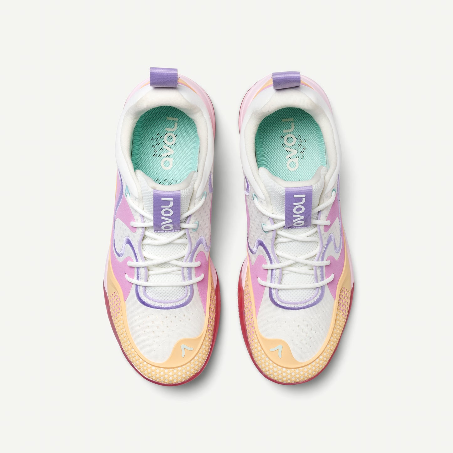 Colorful low top volleyball sneaker with a white, pink, yellow, and red design on a white background