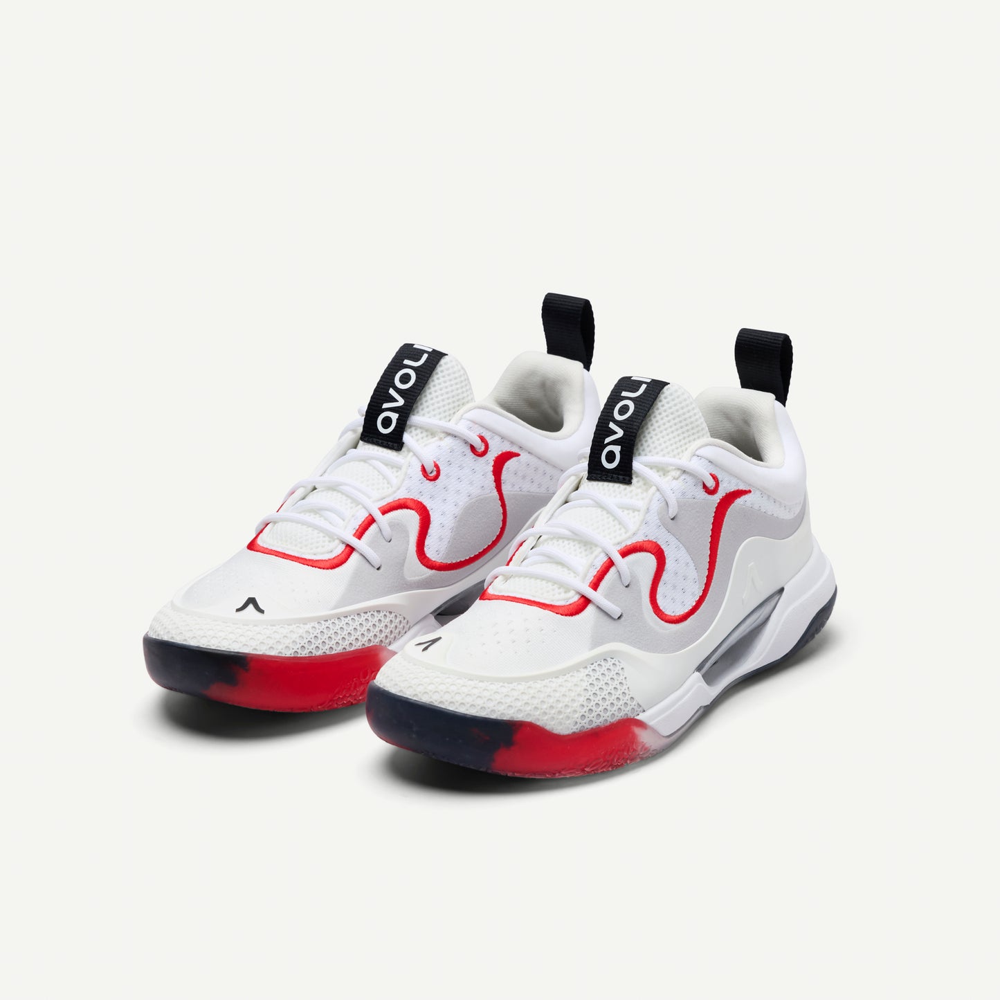 White sneakers with red and black accents on a white background