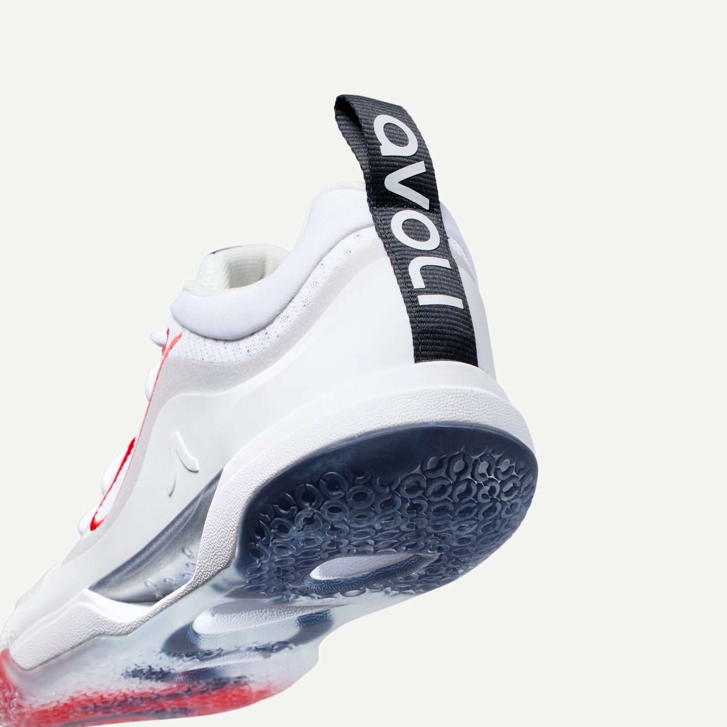 White volleyball low top sneaker with black strap and red accents on a white background