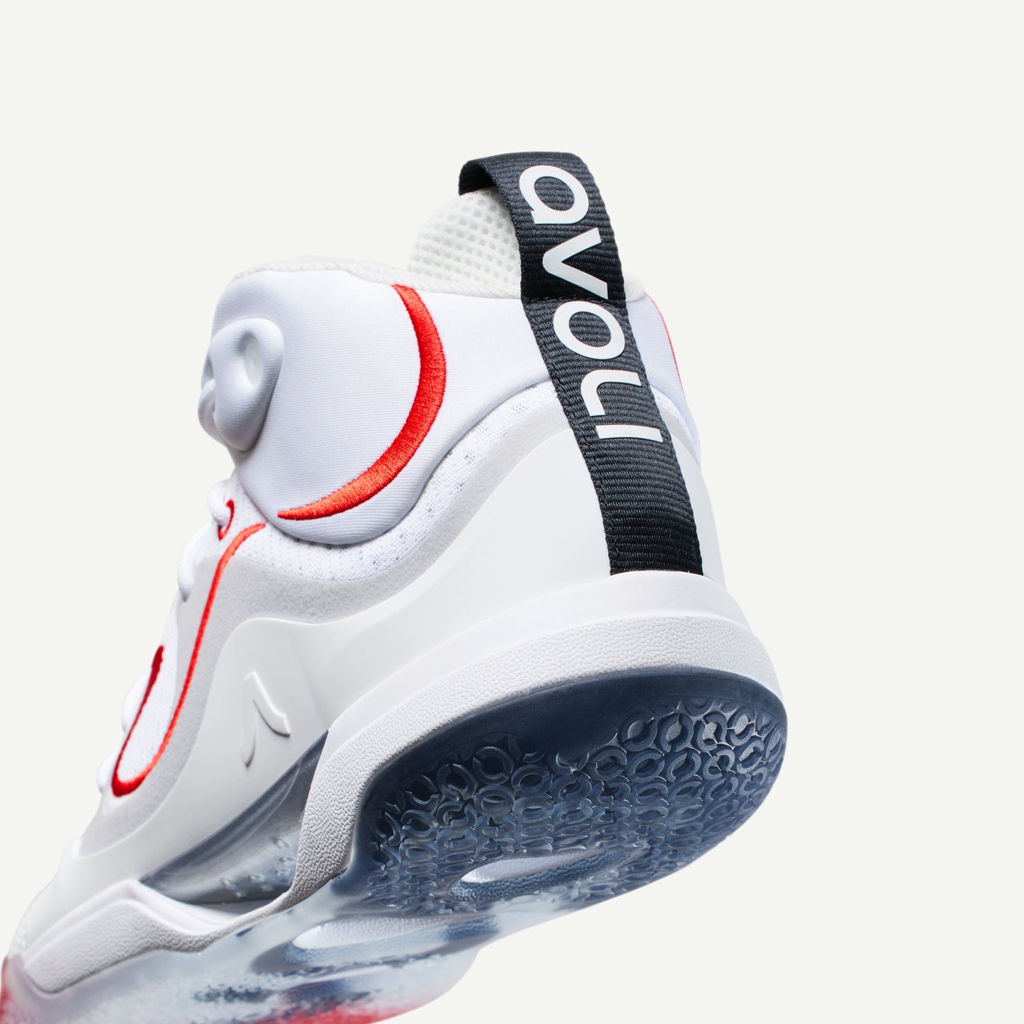 White mid-top volleyball sneaker with red accents on a white background