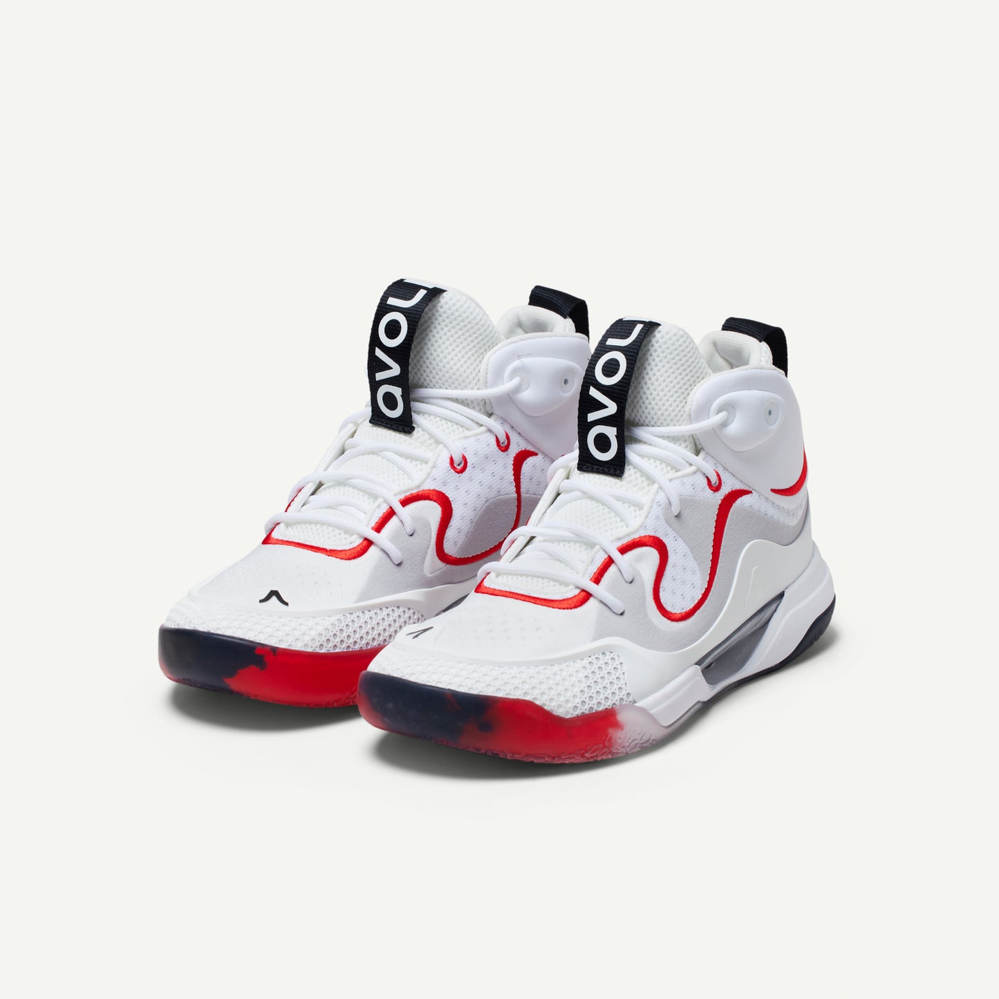 White mid-top volleyball sneakers with red accents on a white background