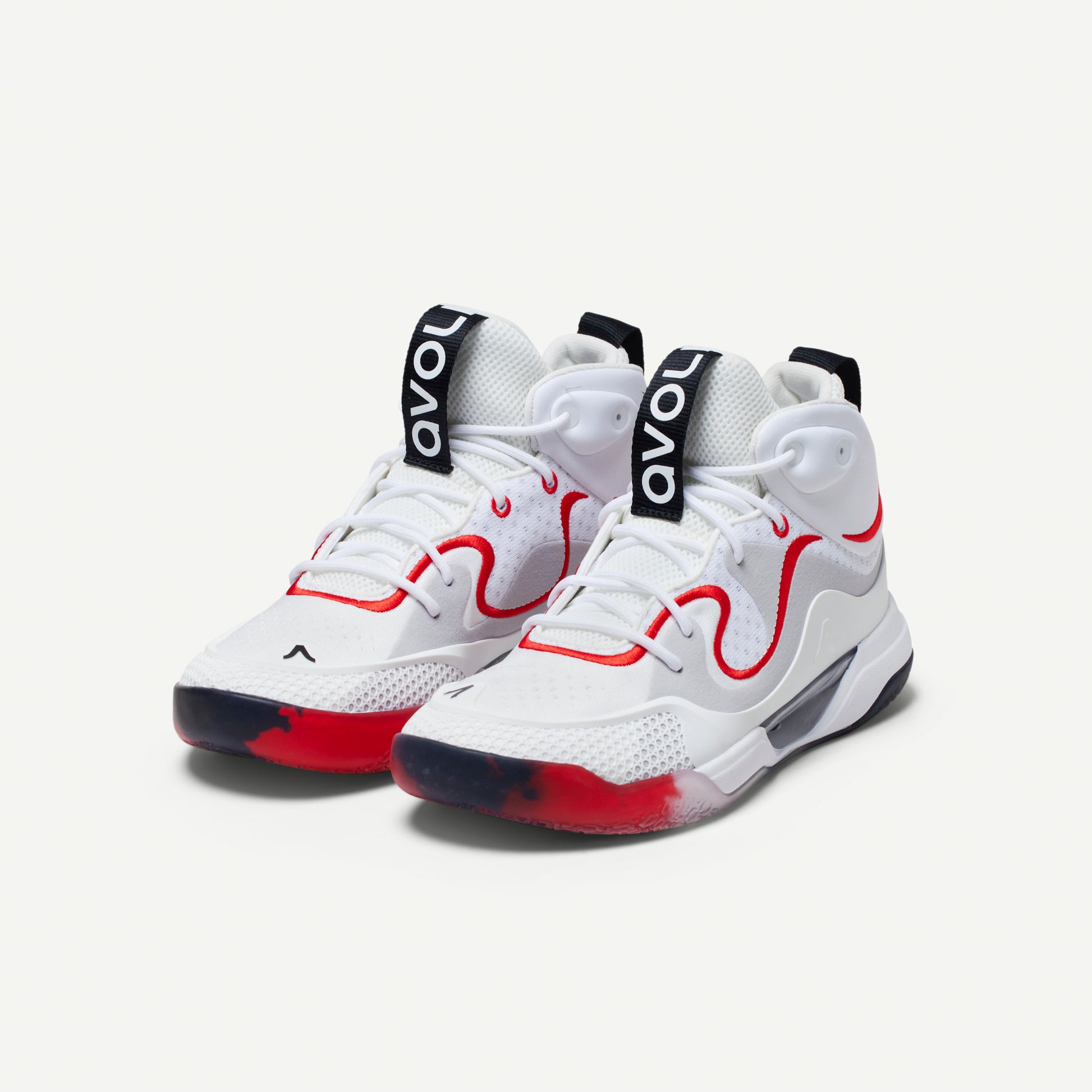 White mid-top volleyball sneakers with red accents on a white background